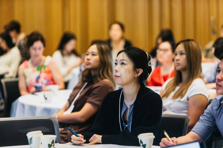 Attendees listening attentively at the VFLI Conference Highlights 2026 session.