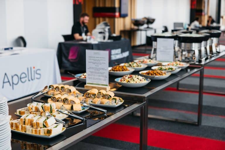 Conference catering setup with snacks, salads, and beverages at VFLI event.