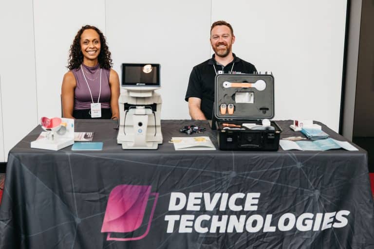 Two professionals showcasing medical device technology at VFLI Conference 2026.