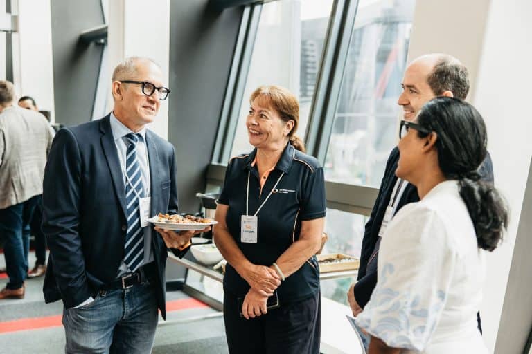 Business professionals engaging in conversation at the VFLI Conference 2026, Australia.