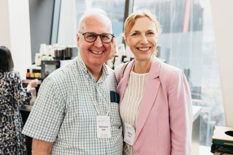 Two smiling professionals at the VFLI Conference 2026, networking indoors.