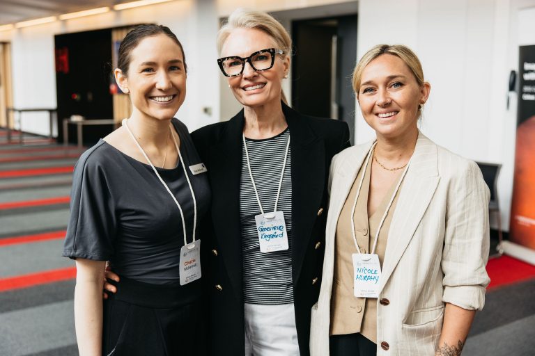 Three professional women smiling at the VFLI Conference 2026 event.